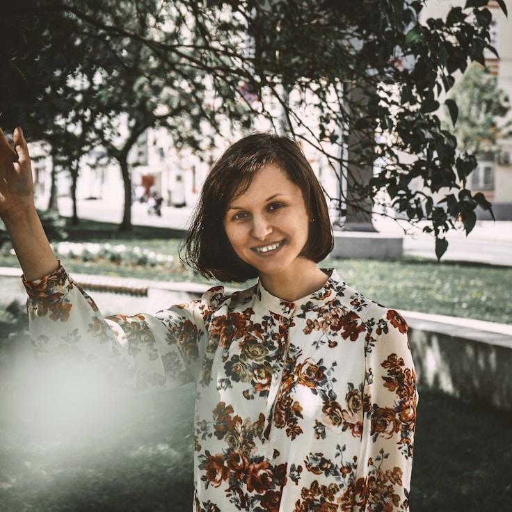 Kaveri Mehta, Lead Design Curator at Quill Marble Harbor, reviewing corporate floral arrangements
